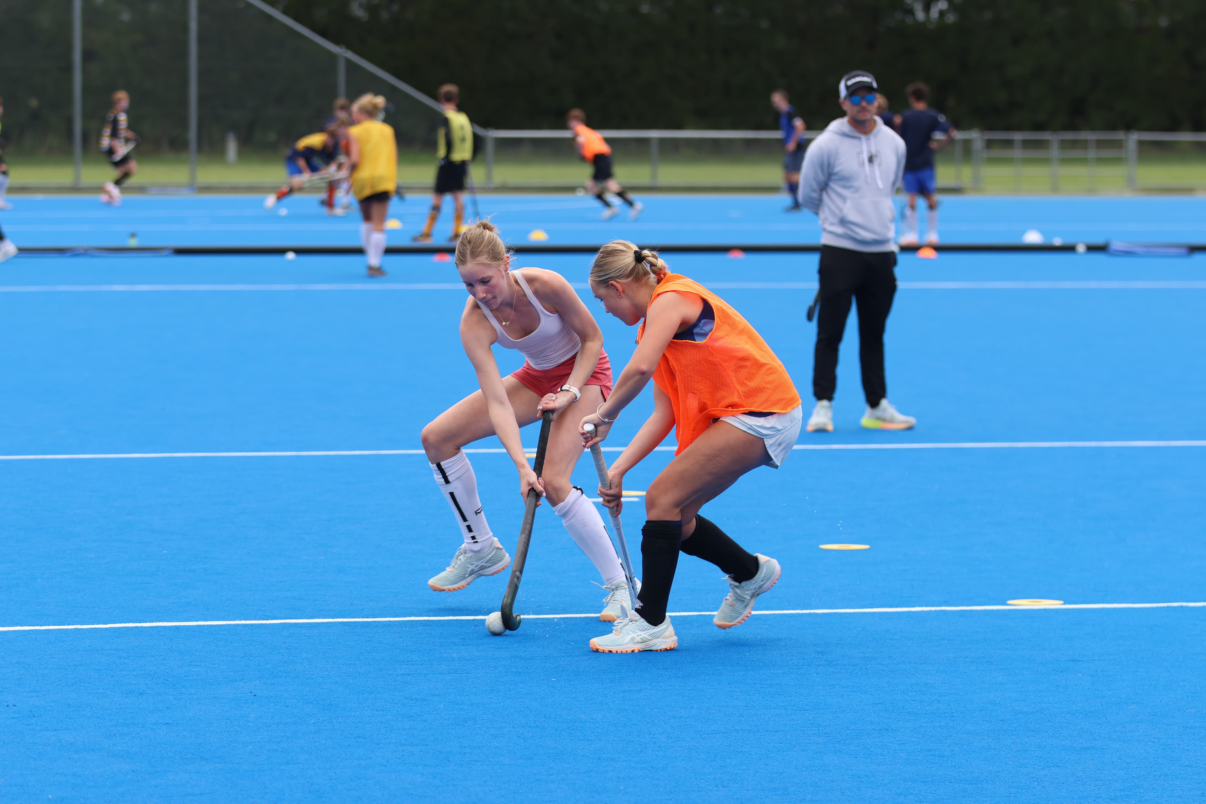 Two players contesting the ball during an Inside Hockey training drill.