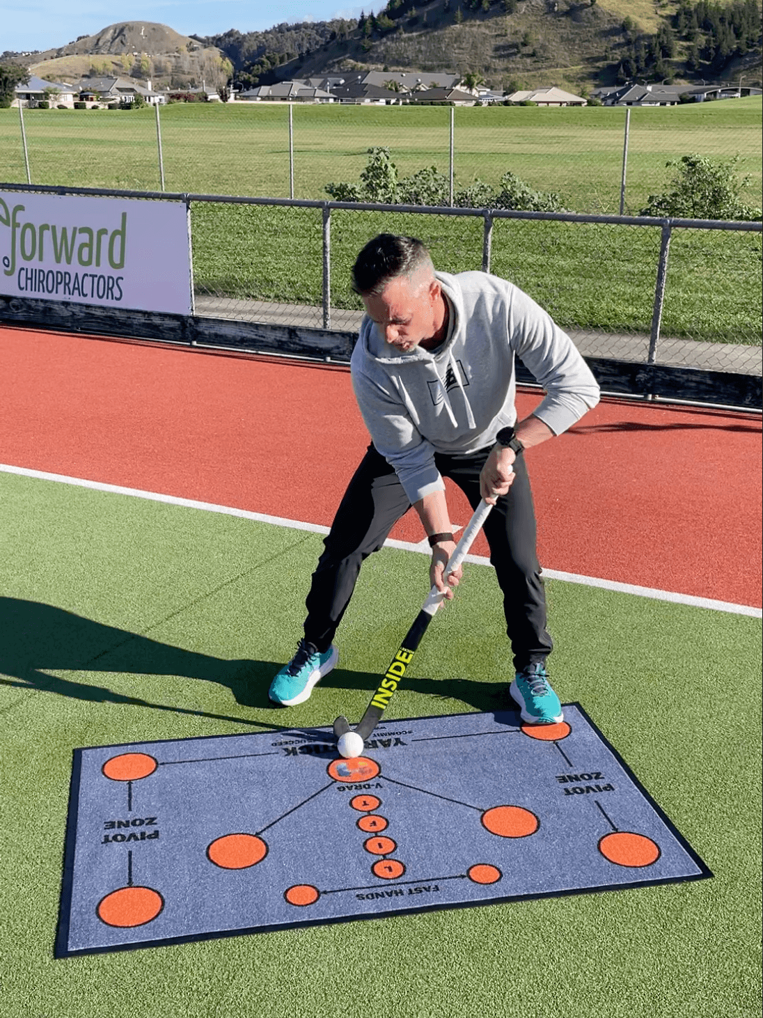Shea McAleese demonstrating ball control on the Inside Hockey Skills Mat.