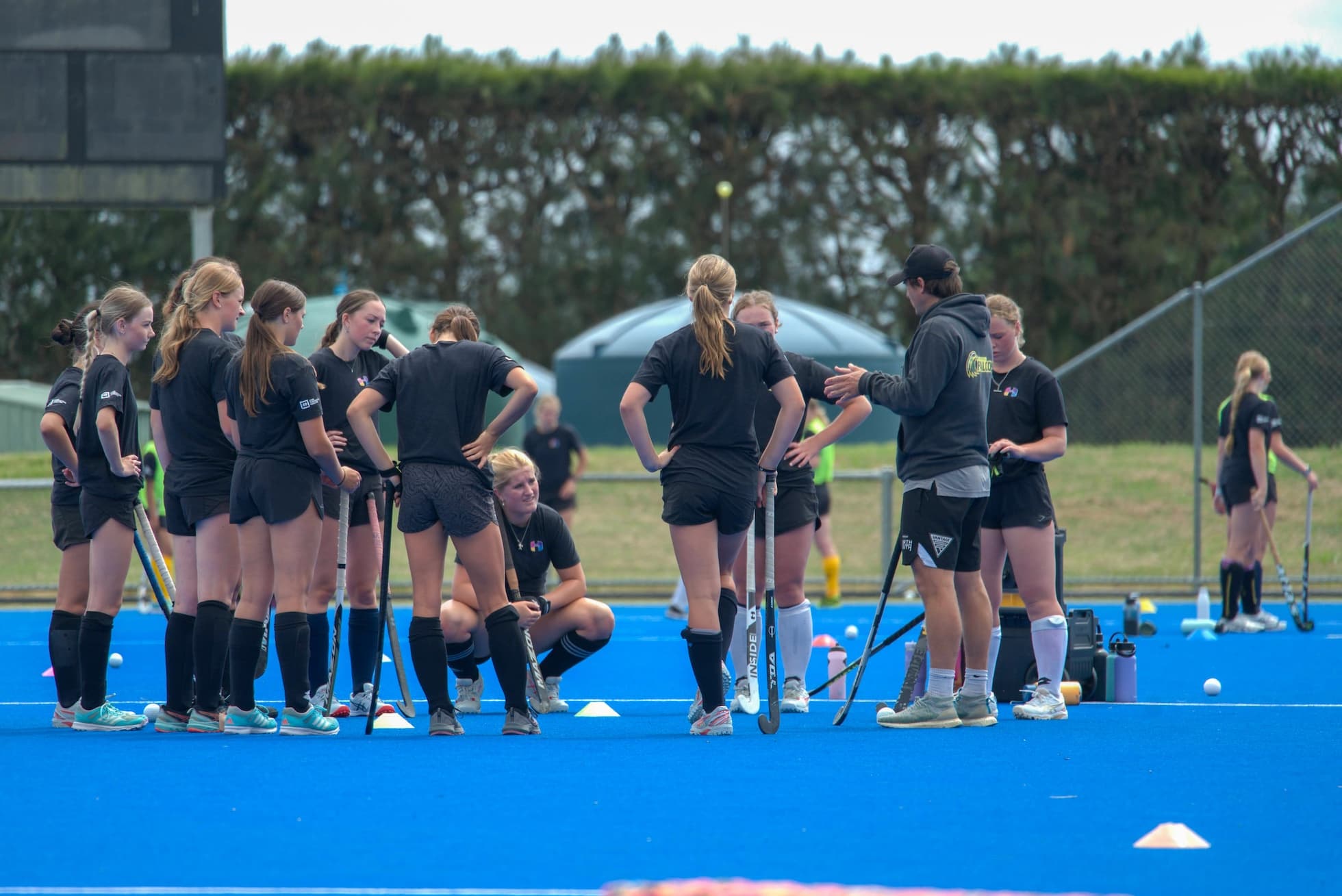 Inside Hockey players listening to a coach during a Camp session.