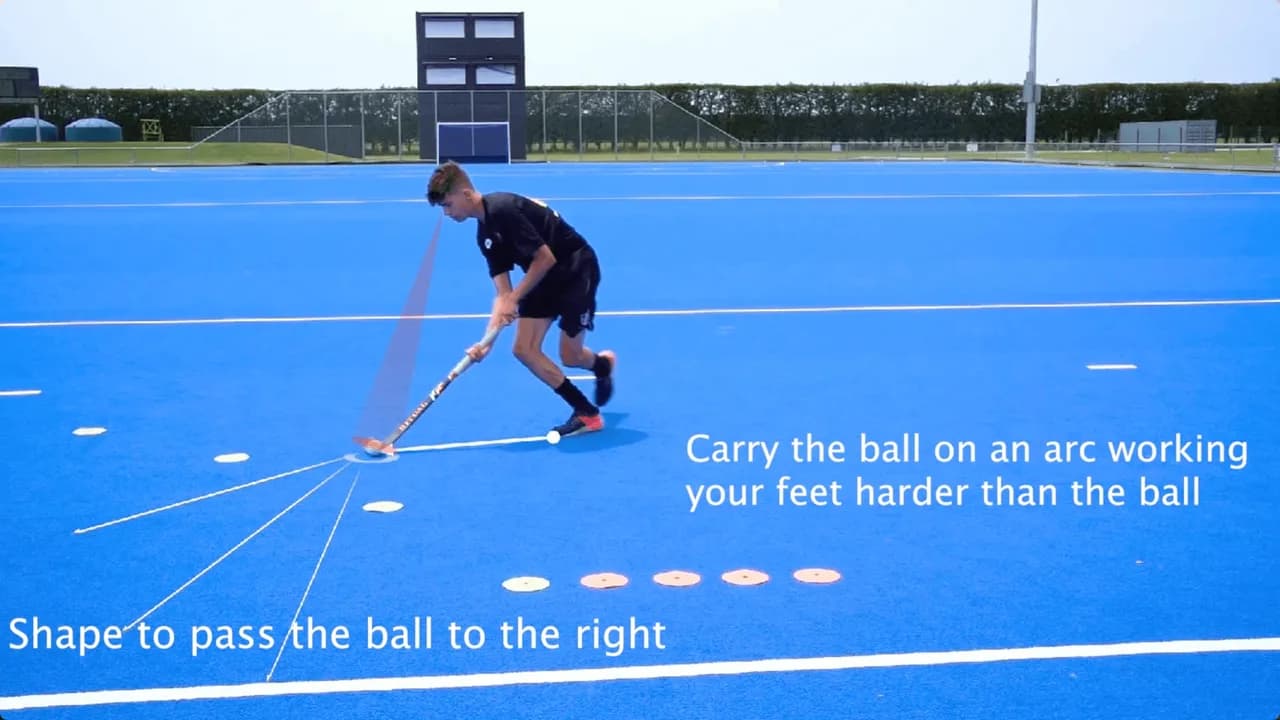 An Inside Hockey player practising a ball-control skill on blue turf.